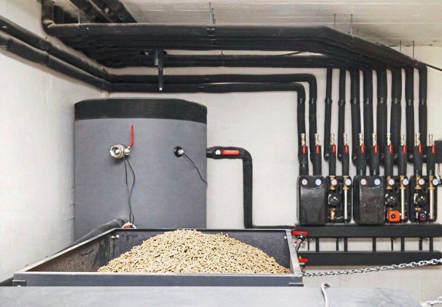 Buffer_Water_Tank_and_Pellets_Burner_for_Fuel_Boiler_in_Boiler_Room_of_Modern_Heating_System.