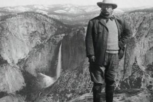 President_Theodore_Roosevelt_posing_against_the_rugged_terrain_of_Glacier_Point_in_Yosemite_Valley_where_he_was_camping_with_John_Muir._Subsequent_to_this_trip,_President_Roosevelt_signed_a_bill_on_June_11,_1906,_declaring_the_valley_as_Yosemite_National_Park,_and_effectively_putting_it_under_the_control_of_the_Federal_Government.