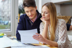 Couple with renovation plans studying a letter