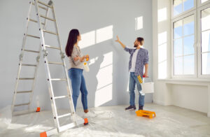 Couple painting in a whitewashed room